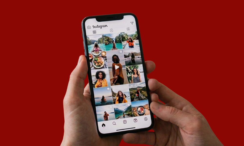 | Instagram Reels vs. TikTok: Which is Better for Brands? A person holding a smartphone showing the polished Instagram feed and video reels layout.
