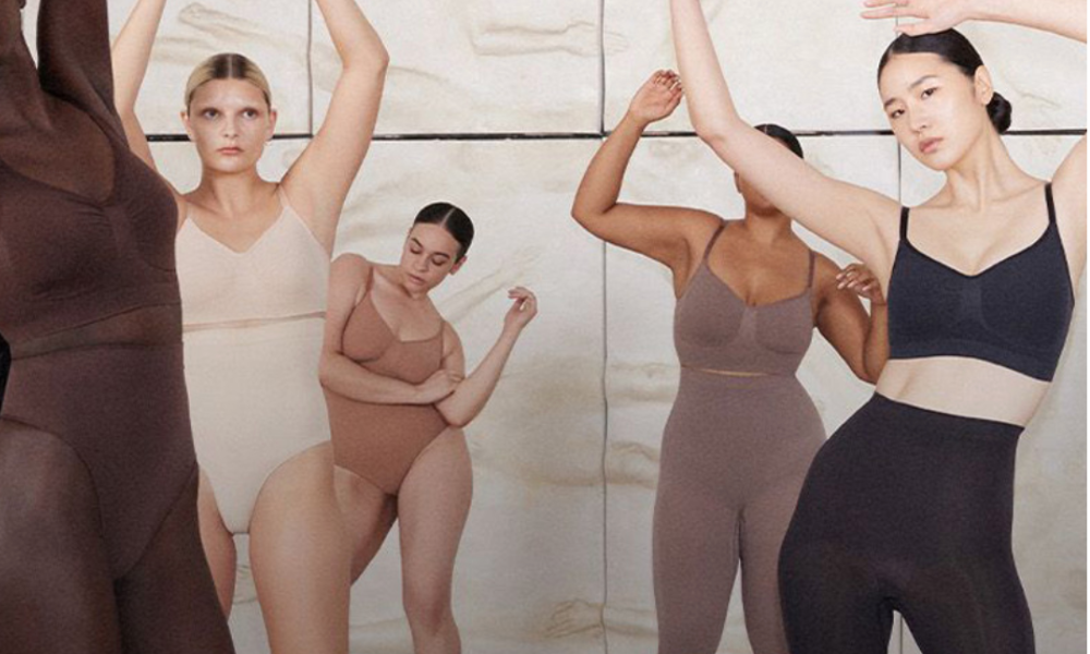 | SKIMS Bodysuit: The Complete Guide to Kim Kardashian's $5 Billion Shapewear Empire (2026) A group of models demonstrating inclusive sizing and diverse skin-tone shades for the SKIMS shapewear collection