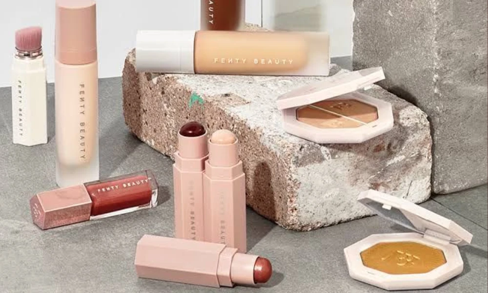 | Fenty Beauty: The Complete Guide to Rihanna's $2.8 Billion Beauty Empire (2025) An overhead flat lay arrangement of Fenty Beauty foundations lip glosses and highlighters