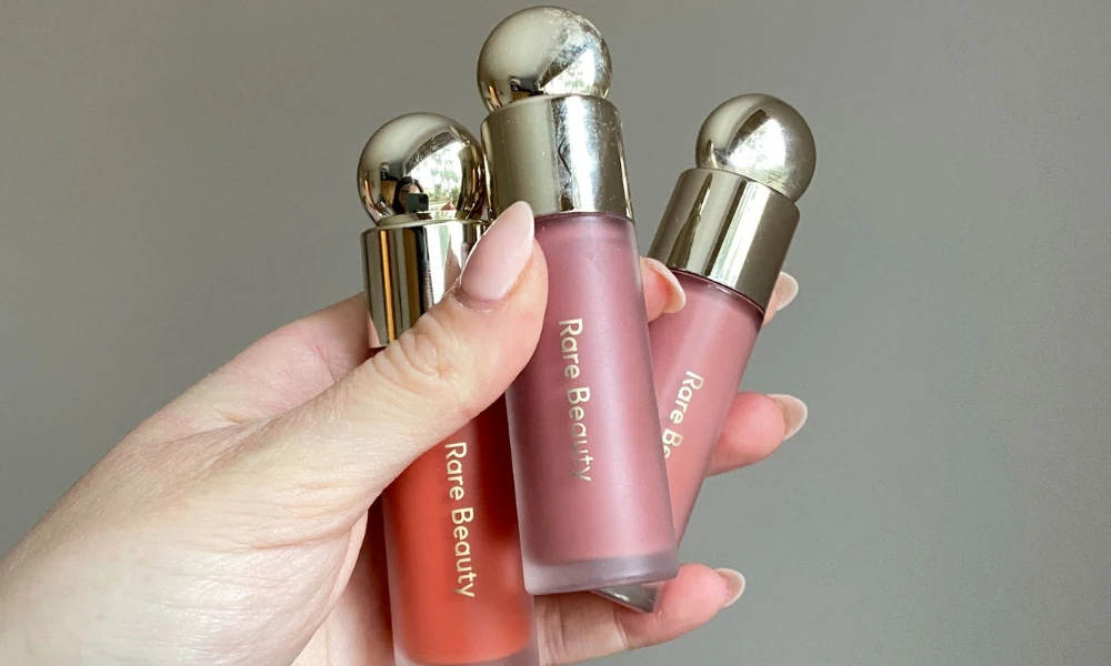 | Rare Beauty: How Selena Gomez Built a $2.7 Billion Beauty Empire on Mental Health & Authenticity Close up view of the viral ultra-pigmented Rare Beauty Soft Pinch liquid blush bottles product design