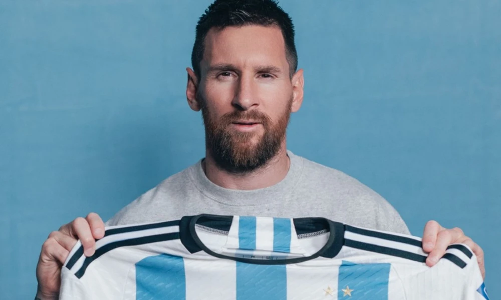 | Messi Jersey Sales: Record-Breaking Revenue From PSG to Inter Miami ($200M+ Impact) Close up studio view of Lionel Messi holding the official vertical stripe football kit jersey