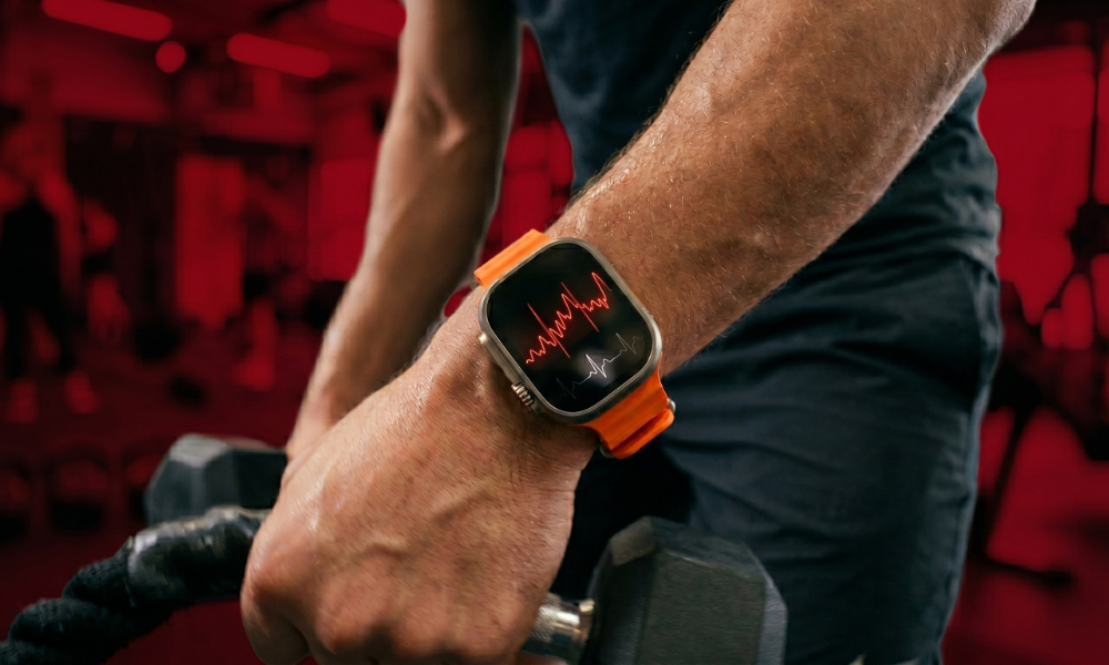 | Fitbit vs Garmin vs Apple Watch: Which Fitness Tracker is Worth It? A close up of a user training with heavy gym ropes monitoring real-time pulse waveforms on an Apple Watch screen