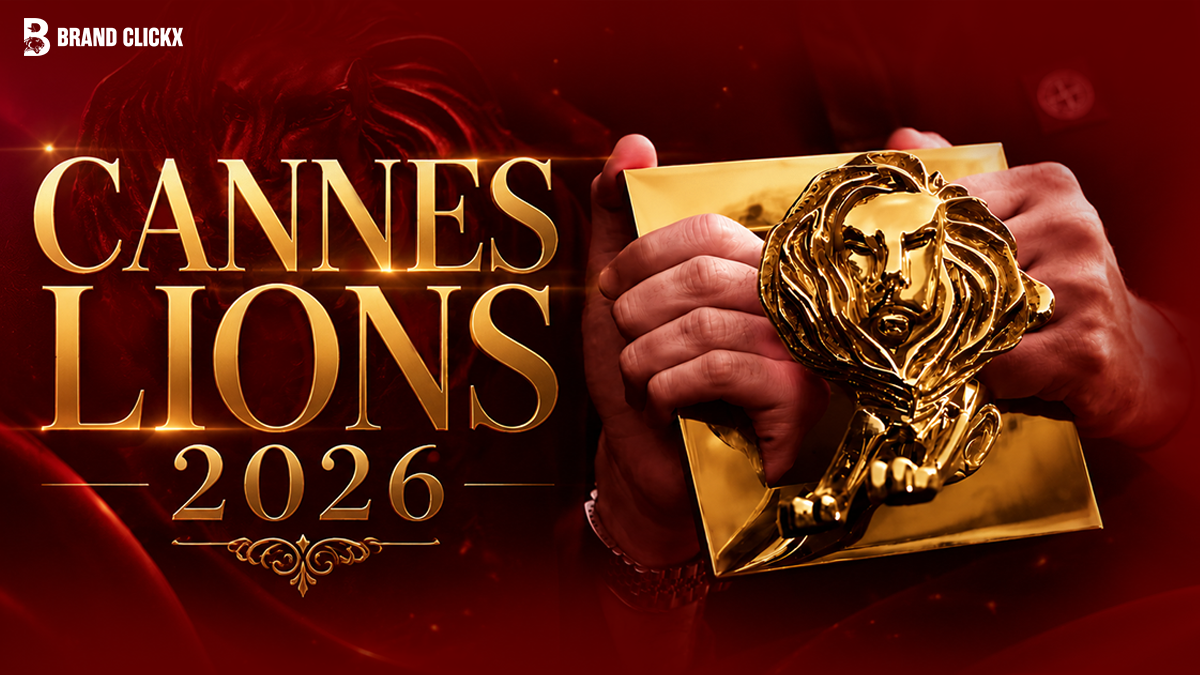 The official Cannes Lions 2026 festival banner displaying a golden lion trophy held in hands against a dark red backdrop under the BrandClickX logo