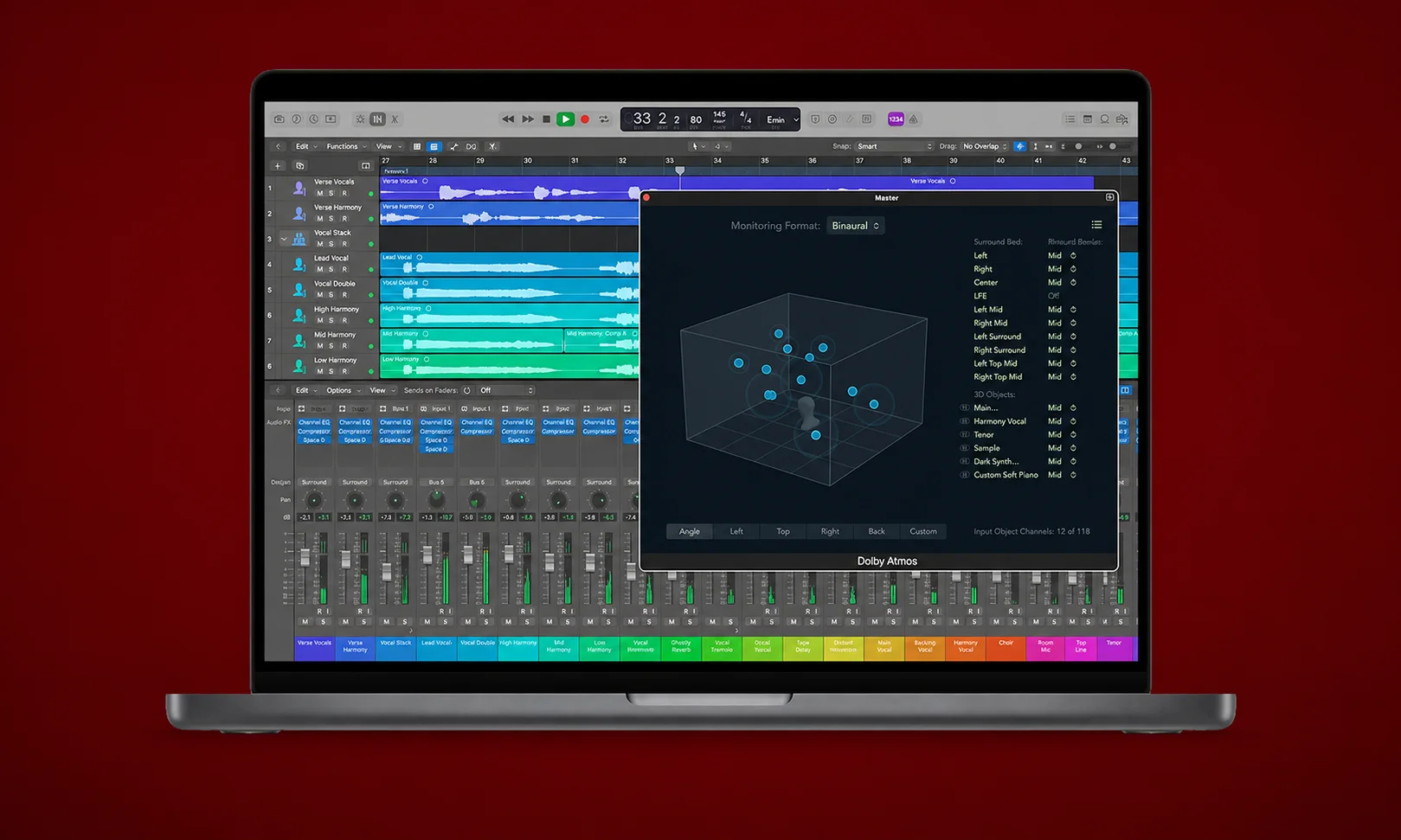 An open laptop displaying Logic Pro timelines against a red ambient background