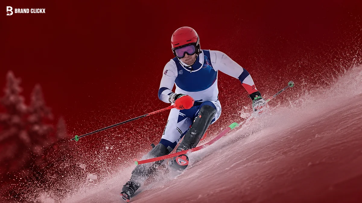 A skier racing downhill on a snow-covered slope against a deep red background