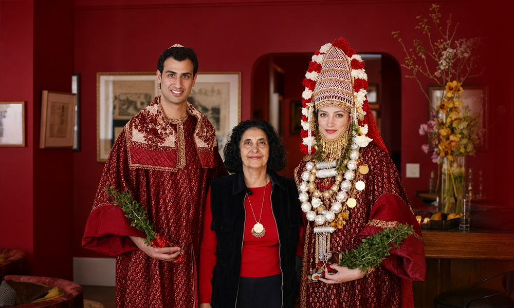 | 150+ Jewish Last Names and Their Origins Explained A family dressed in formal attire posing for a portrait in deep red.