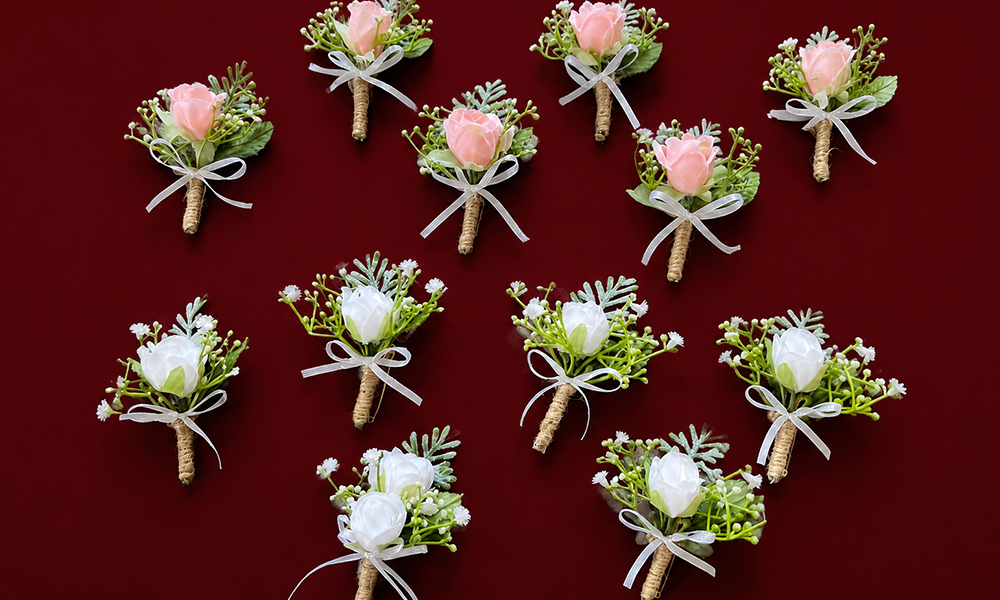 | Corsage vs Boutonniere Guide: 2026 Trends, Styles & Buying Tips Assorted floral boutonnieres arranged on a deep red background.
