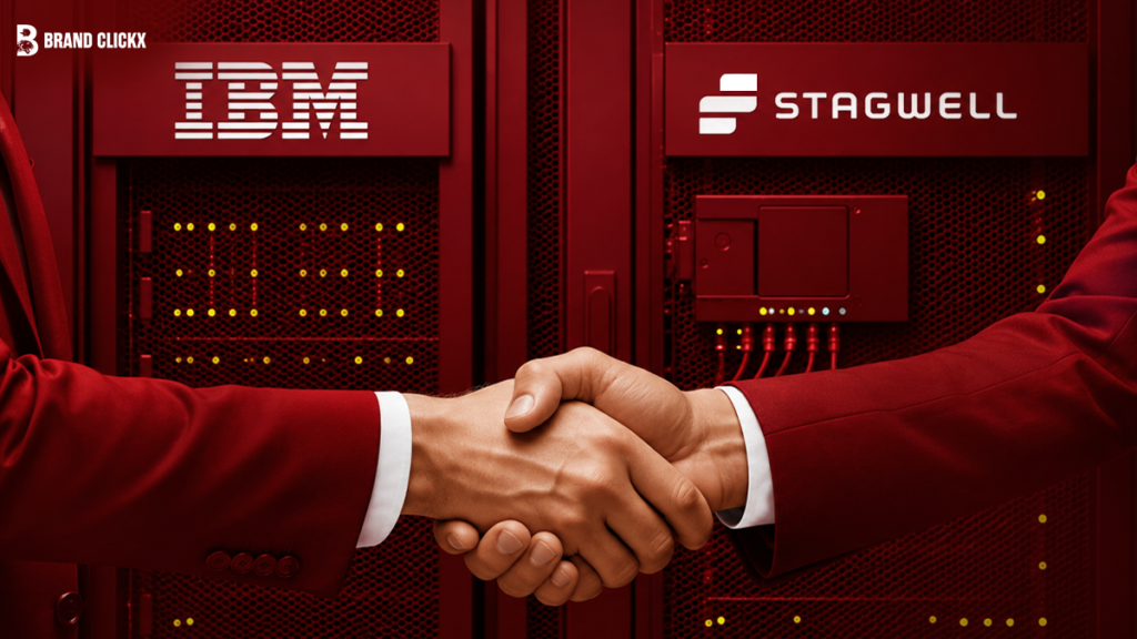Artboard 34 Two people in red suits shaking hands in front of IBM and Stagwell logos.