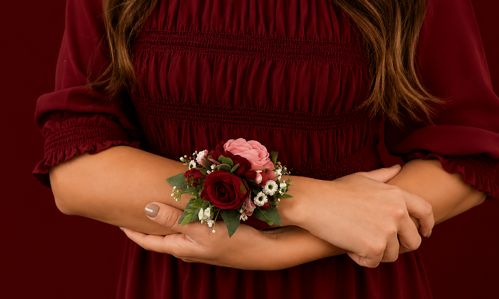 | Wrist Corsage Near Me: How to Find, Order and Choose the Perfect One in 2026 Hands held together displaying a floral corsage with deep red tones.