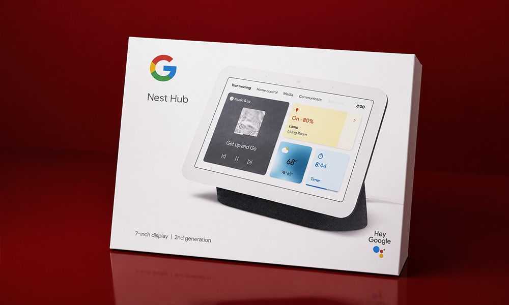 Google Nest smart display product box packaging displayed on a dark red tabletop setup