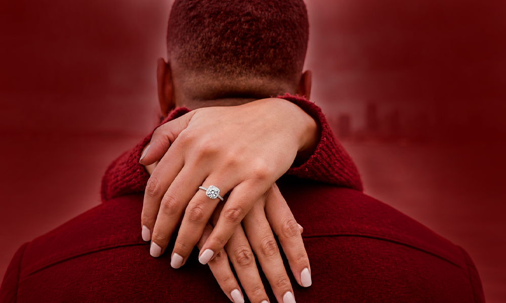 A close-up view of hands wearing a wedding ring.