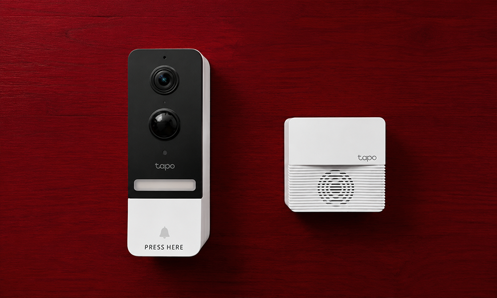 | 15 Best Video Doorbells Compared Wireless smart video doorbell unit displayed upright alongside its matching indoor chime receiver box on a red background