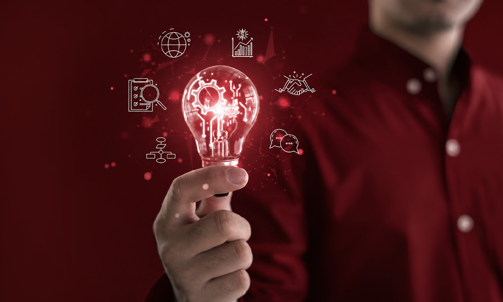 A person holding a glowing light bulb, symbolizing a new idea.