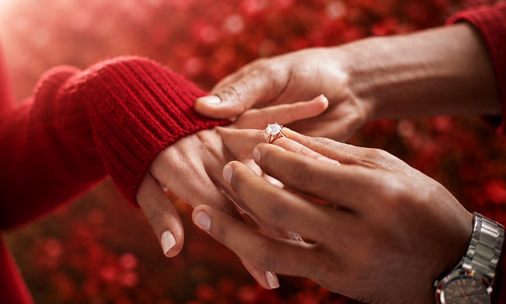 A detailed shot of hands exchanging wedding rings.