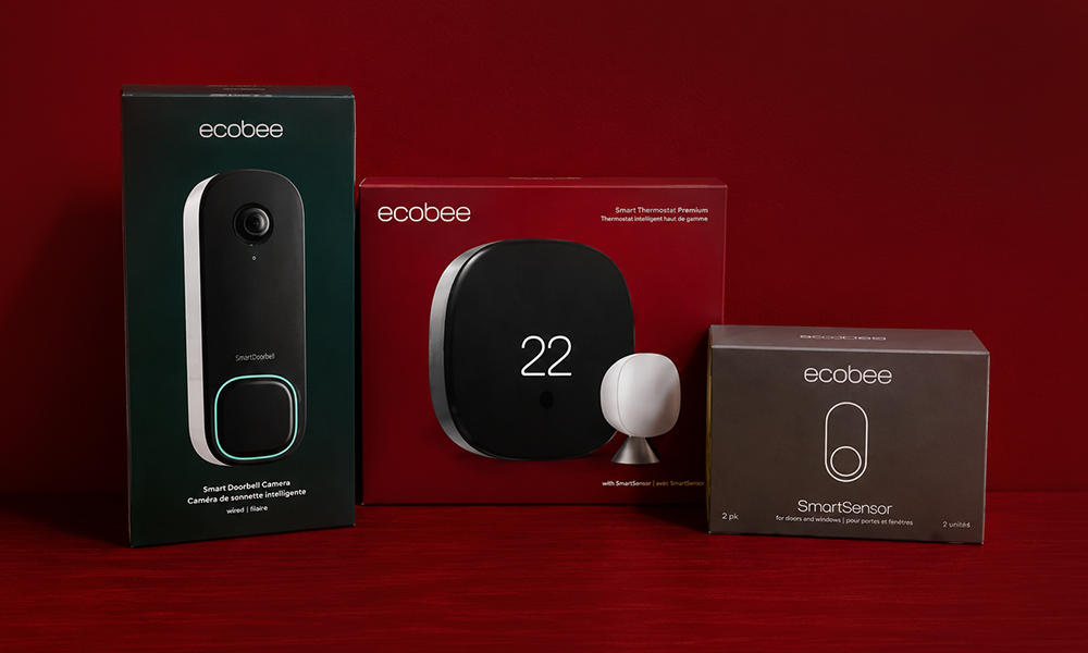 | 15 Best Video Doorbells Compared Smart video doorbell retail box packaging displayed neatly alongside hardware accessories on a dark red tabletop