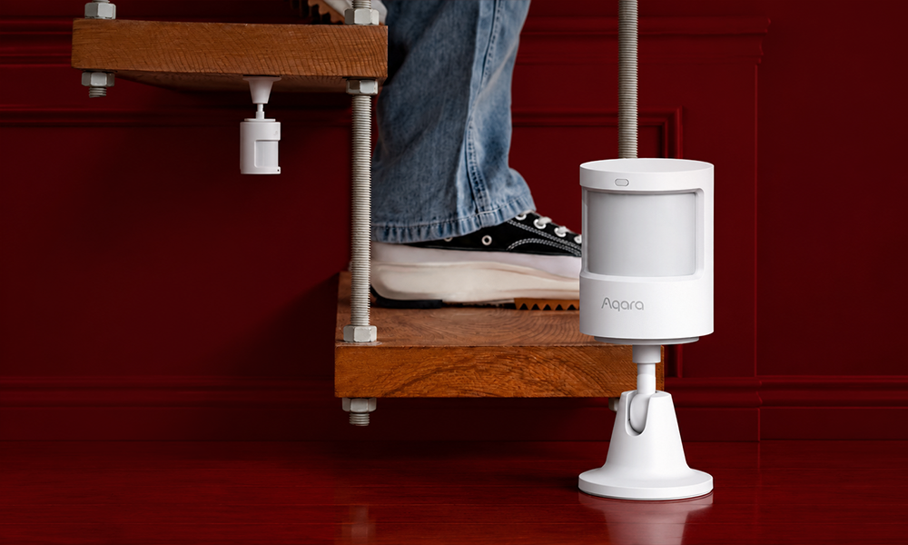 An automated robot vacuum cleaner navigating across a wooden floor near stairs during a cleaning cycle