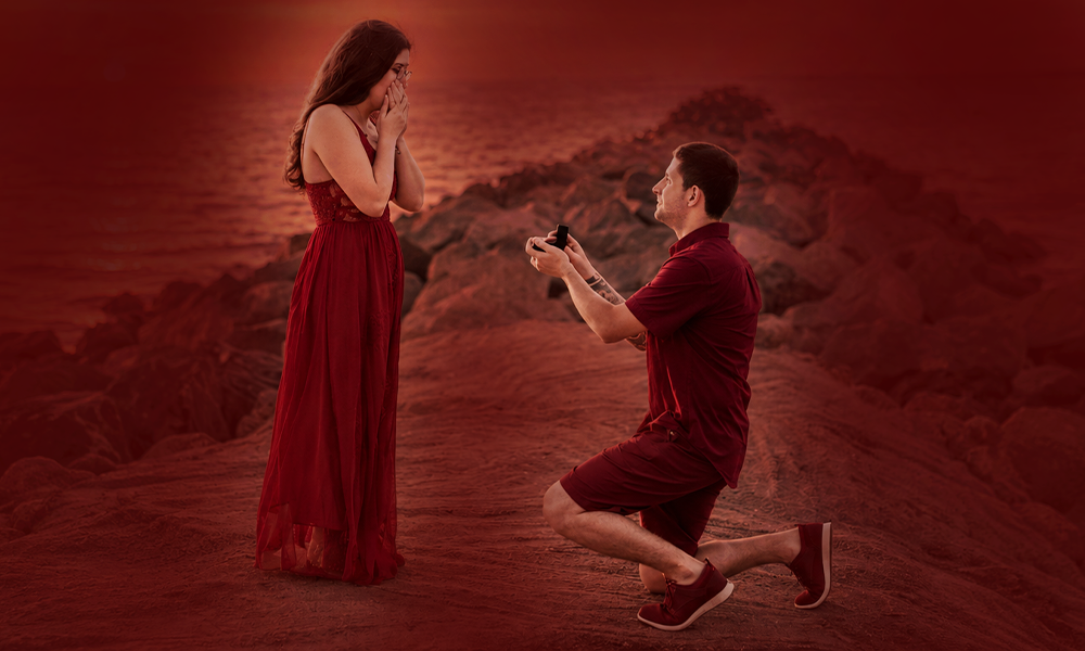 A man proposing to a woman, set against a deep red background.