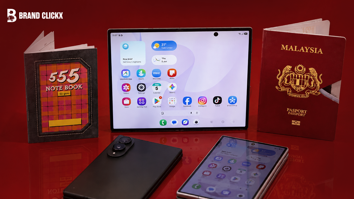 Collection of digital devices including a foldable tablet, smartphones, a notebook, and a Malaysia passport on a red surface