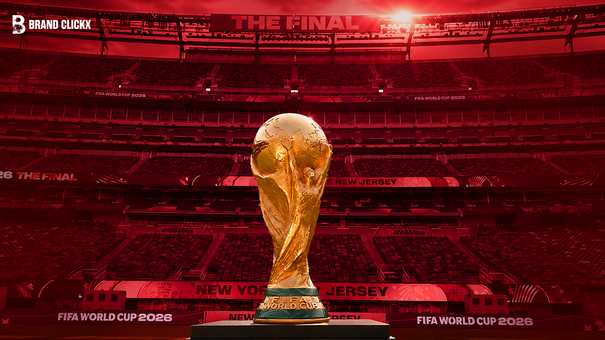 fifa-world-cup-2026-final-trophy The FIFA World Cup trophy inside a stadium, with Brand ClickX branding and 2026 final signage on a deep red background.