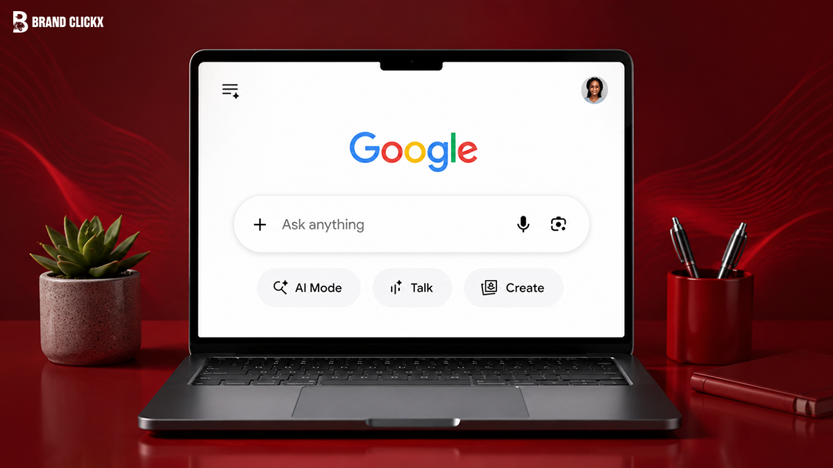 A laptop displaying the Google search homepage interface with AI Mode, Talk, and Create options on a red desk setup
