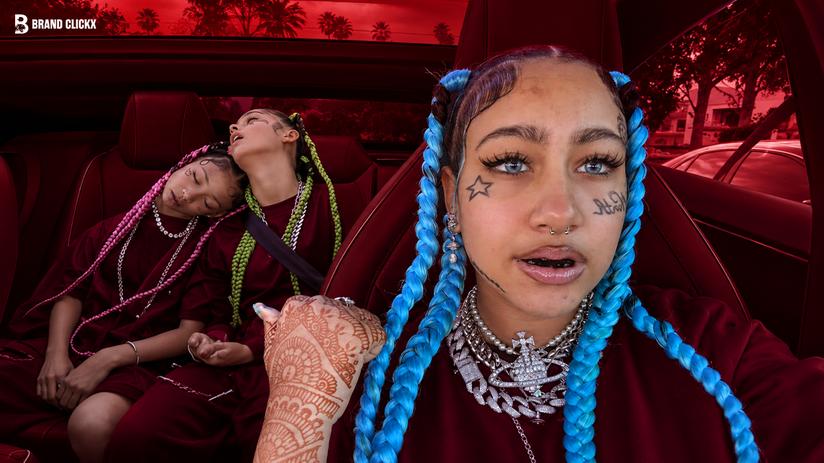 young-woman-with-bright-braids-car A young woman with blue braids and facial tattoos sitting in a car with the Brand ClickX logo.