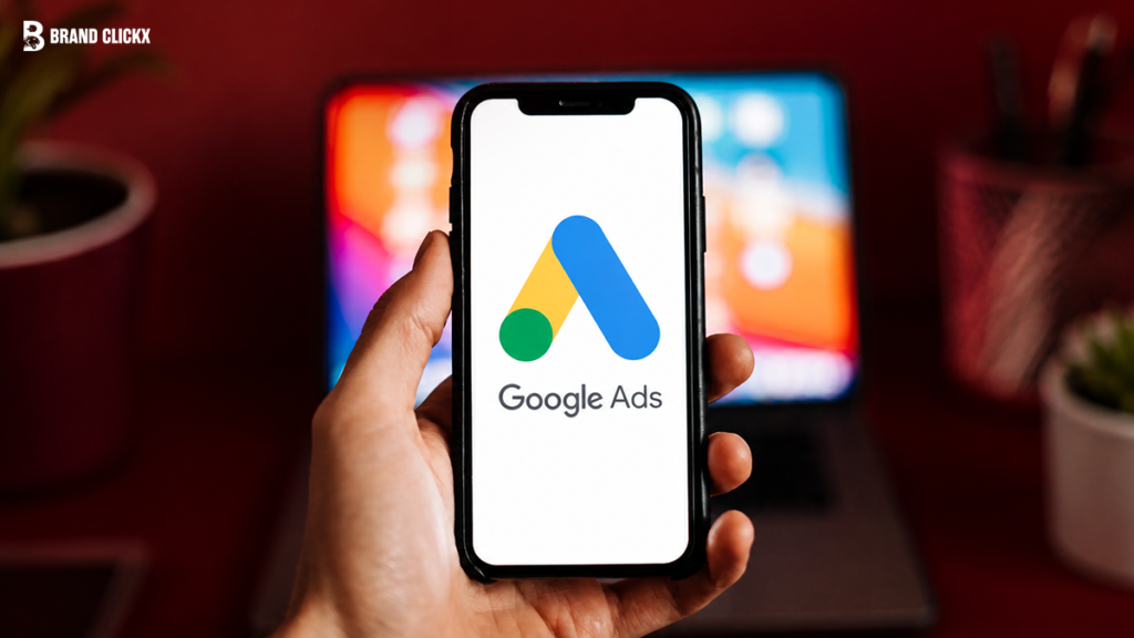 google-ads-mobile-app-interface A hand holding a mobile phone displaying the Google Ads app interface.