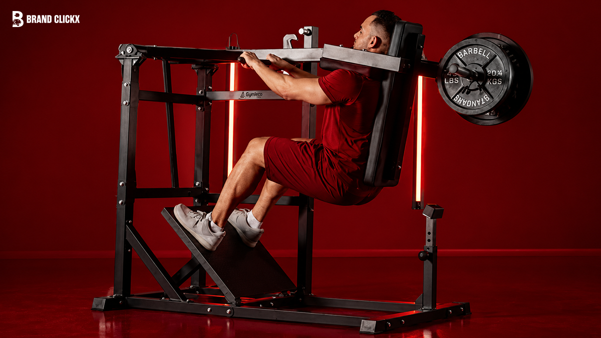 Person performing a seated machine exercise against a deep red aesthetic by Brand ClickX.