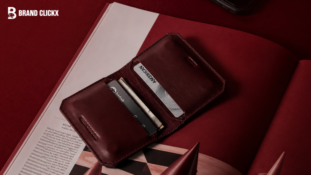 A person holding an open leather wallet.