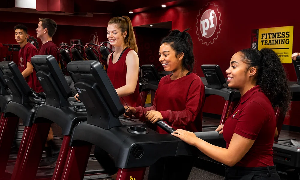 Weight training equipment set up in a red-lit fitness center