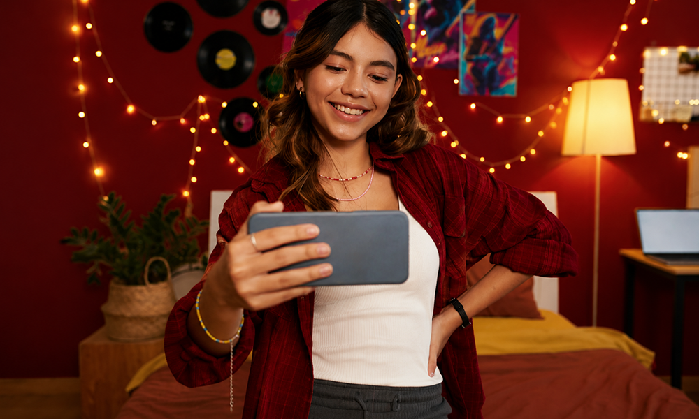 Young social media girl recording interactive video on phone