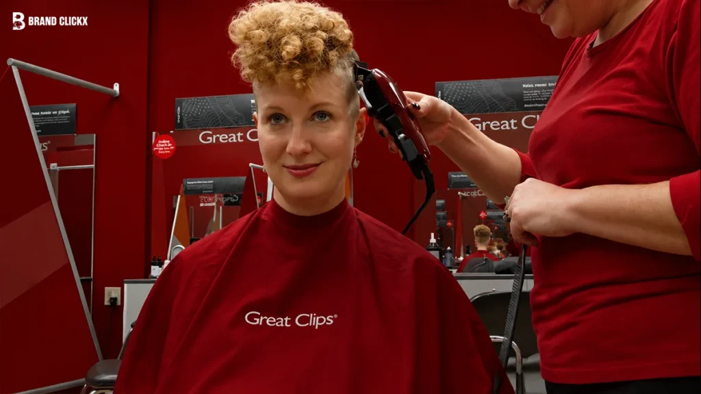 Great Clips Near Me A customer getting a haircut in a salon with red-themed decor