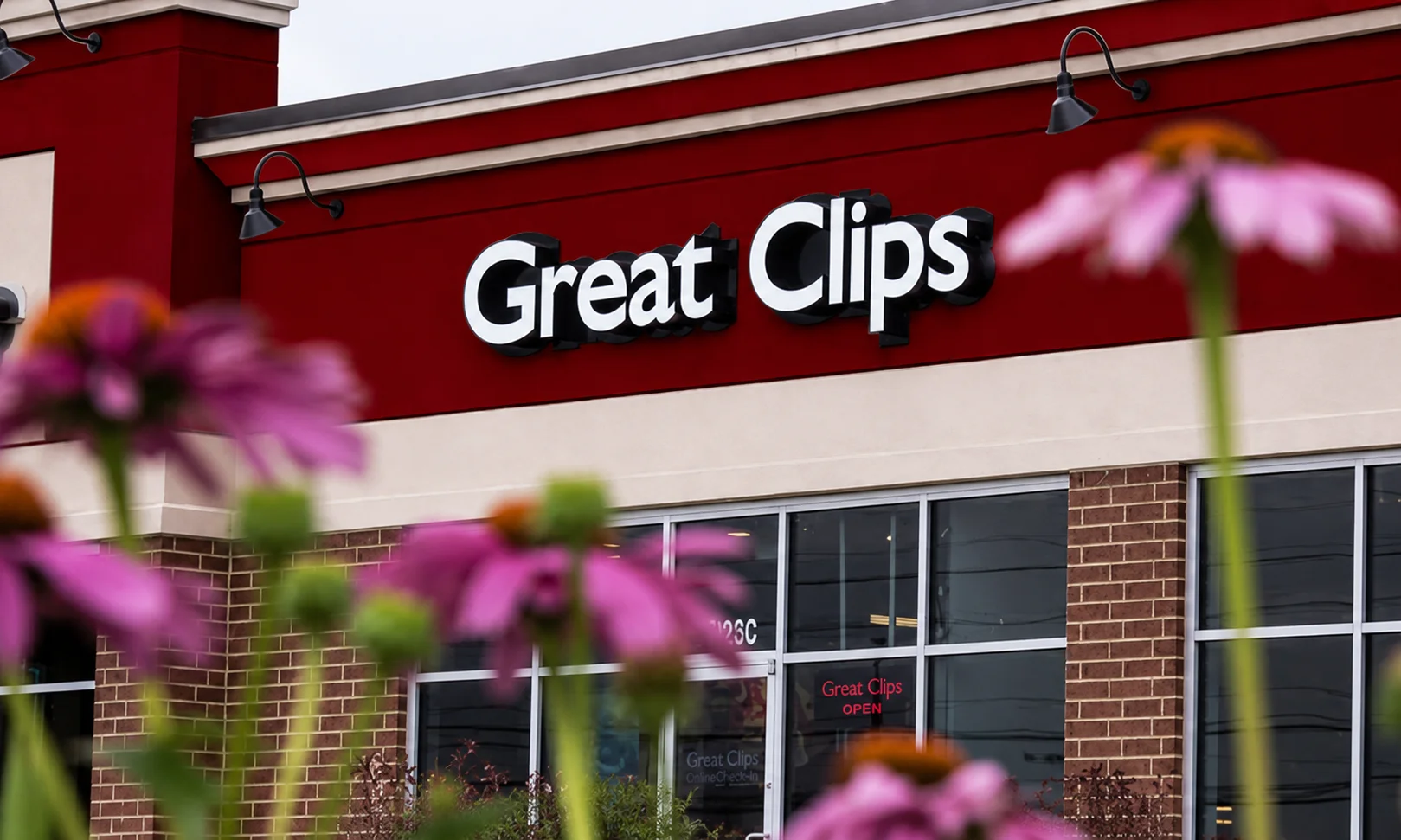 | Great Clips Near Me: Prices, Hours & Deals 2026 Exterior view of a Great Clips salon storefront with red signage