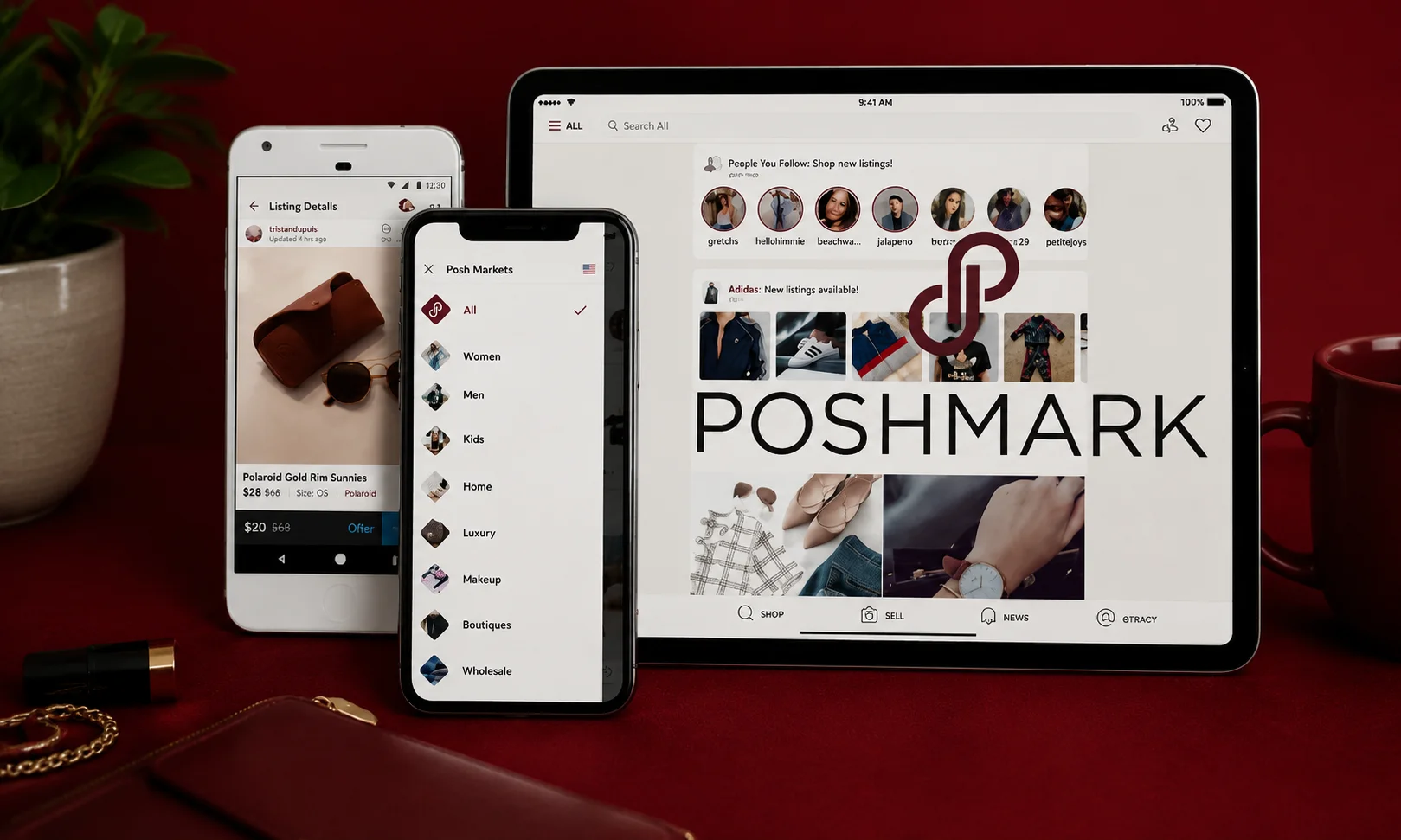 Smartphone and tablet displaying the Poshmark platform on a dark red desk