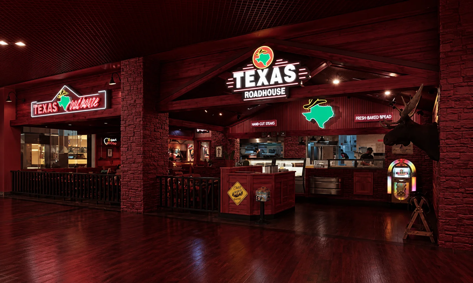 Interior view of a Texas Roadhouse dining room with warm red lighting