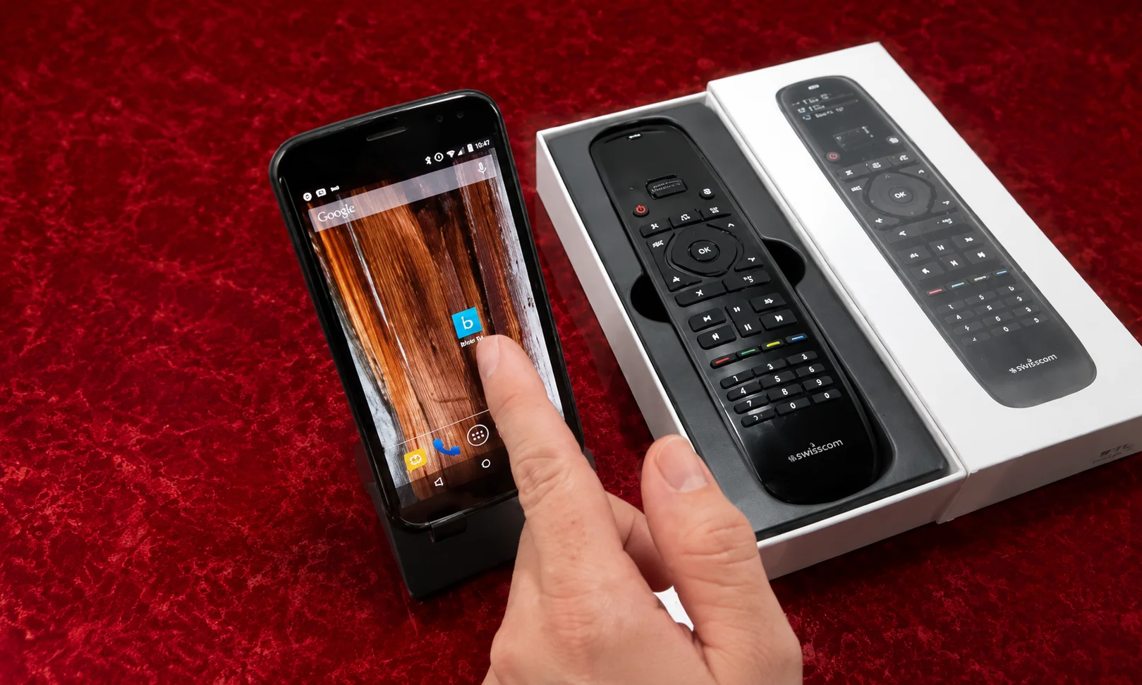 Smart universal remote control setup on red surface