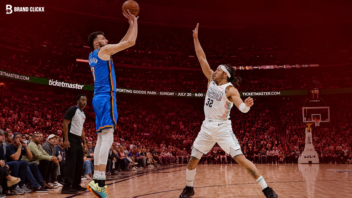 Two basketball players on a court during a game under a dark red ambient lighting