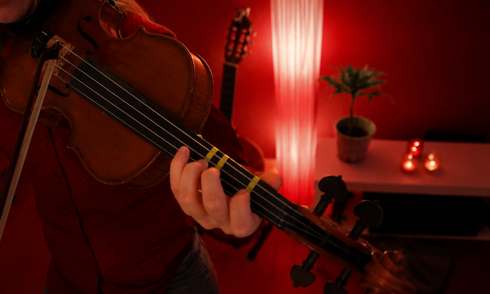 Group of students in a violin practice class with instructor