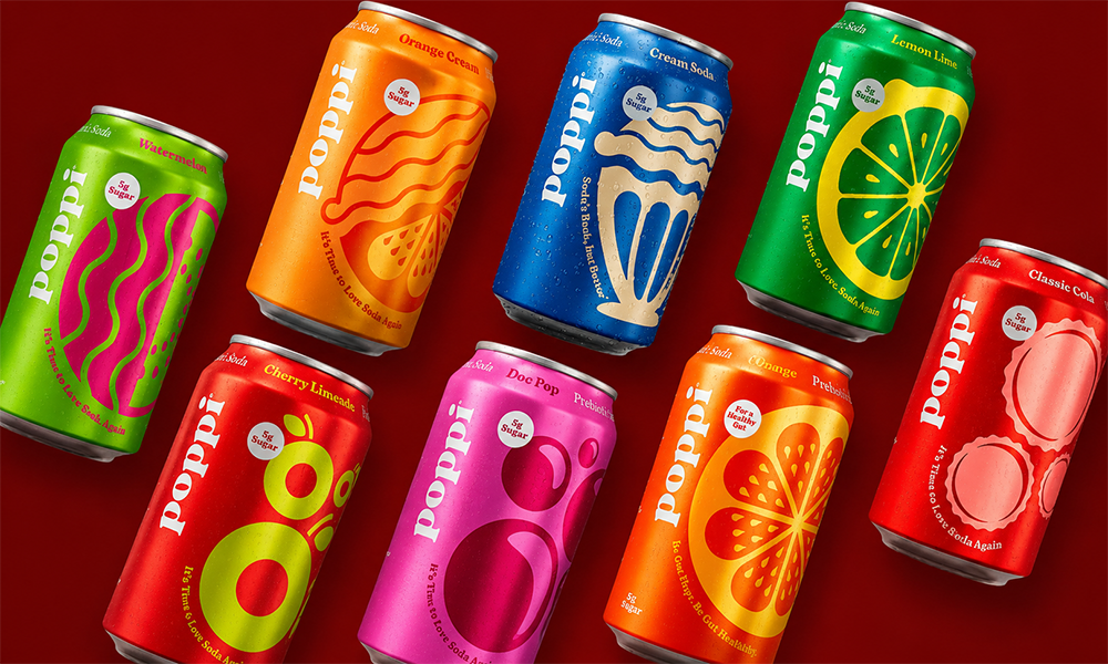 | Poppi vs Olipop: A Complete Side-by-Side Comparison (2026) Multiple colorful cans of Poppi prebiotic soda including watermelon orange cream doc pop and classic cola flavors