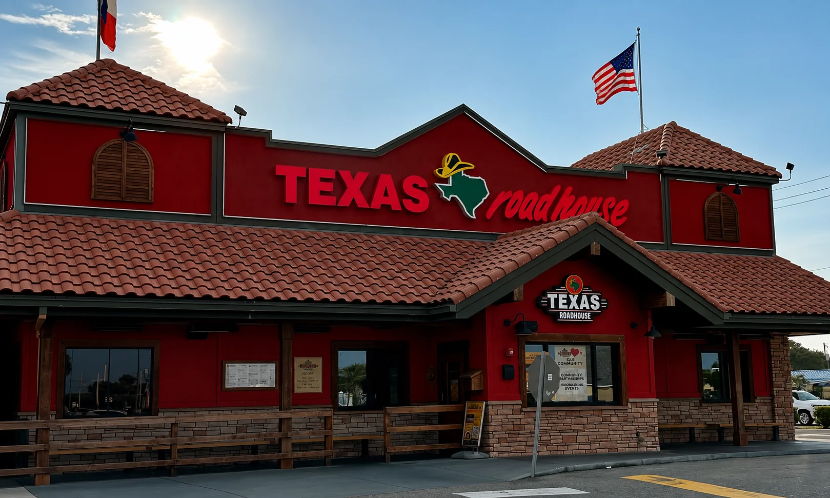 Exterior view of a Texas Roadhouse restaurant building under a bright sky