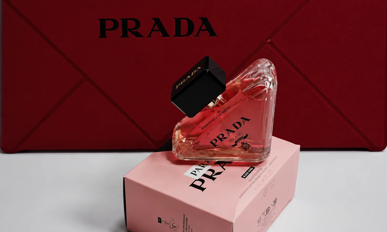 A Prada product presentation box set against a red background.