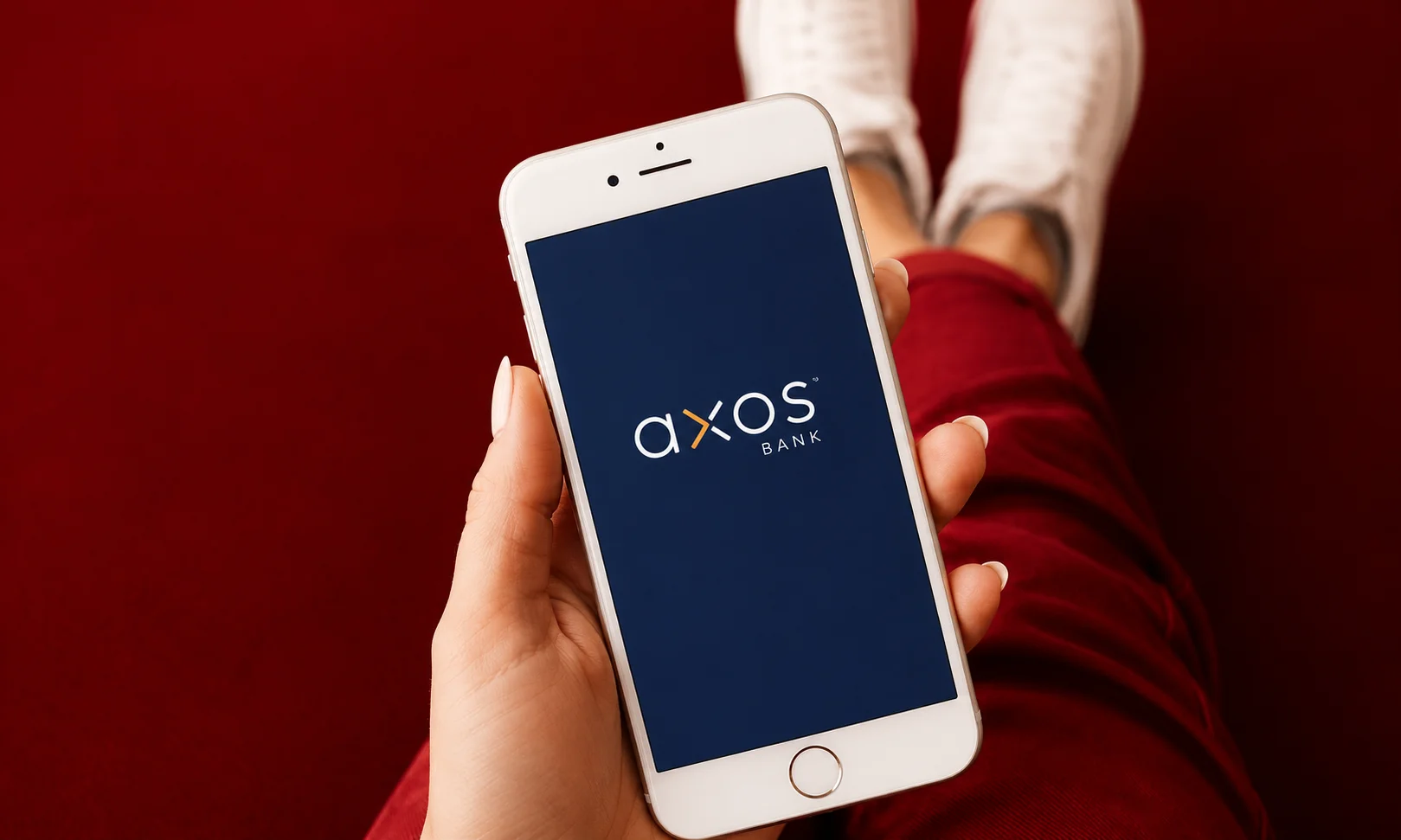 | 15 Best High-Yield Savings Accounts of August 2026 (Up to 4.21% APY) A hand holding a smartphone displaying Axos financial services.