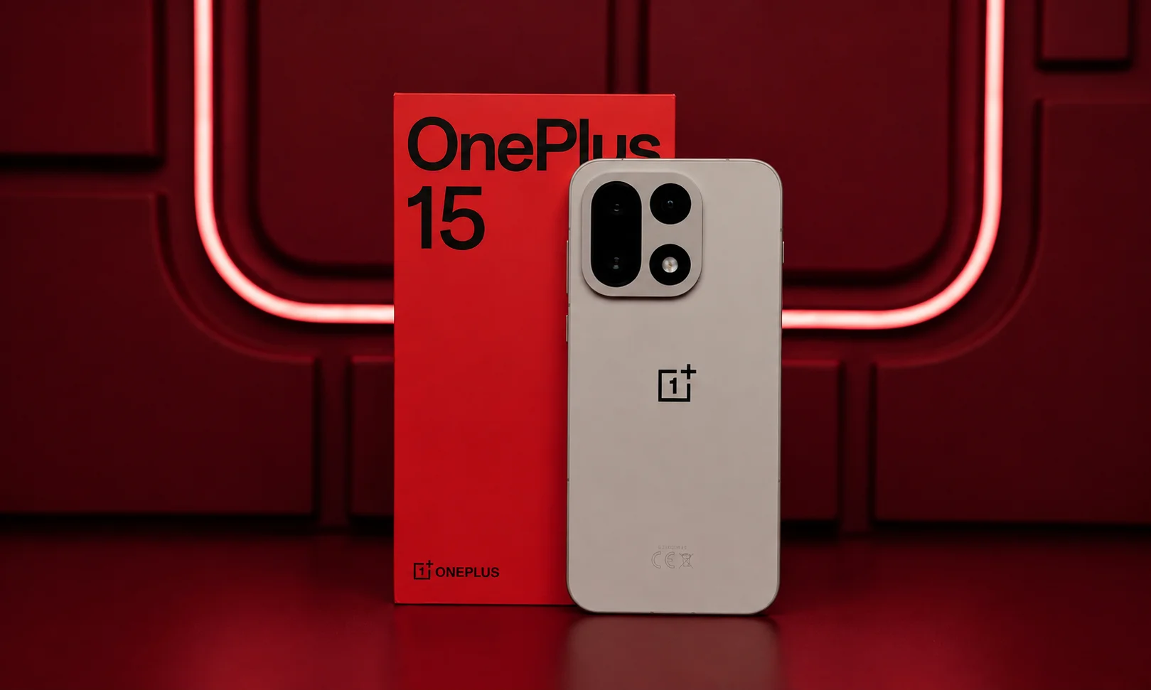 A vertical view of a OnePlus 15 smartphone standing next to its box.