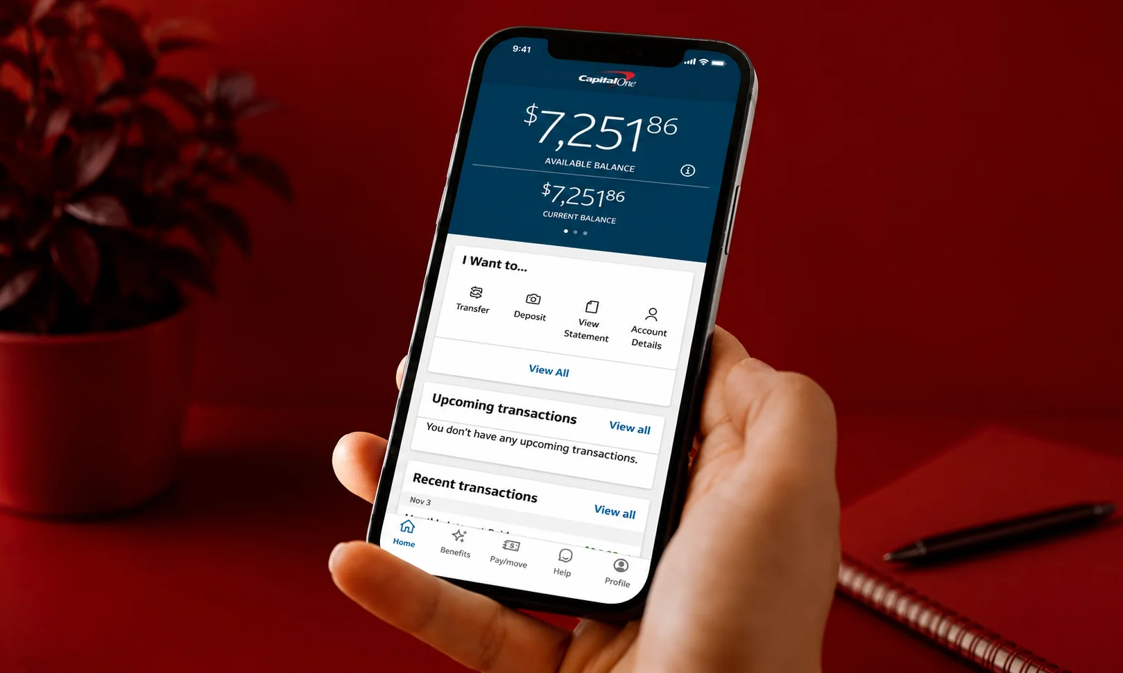 | 15 Best High-Yield Savings Accounts of August 2026 (Up to 4.21% APY) A mobile phone displaying the Capital One 360 app against a red surface.