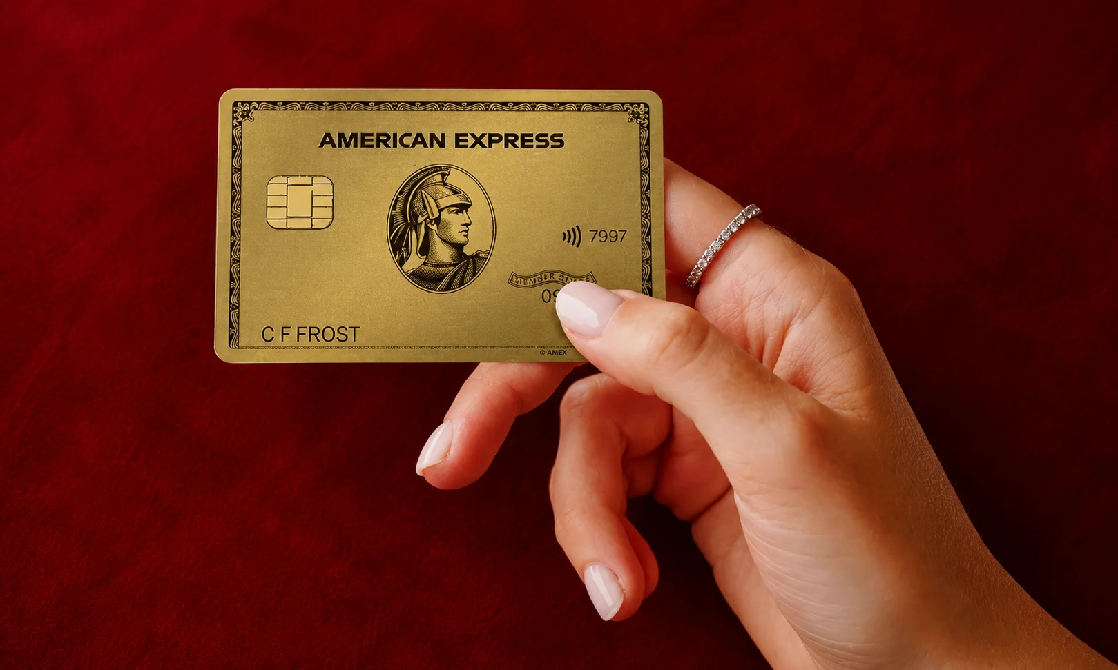| 15 Best High-Yield Savings Accounts of August 2026 (Up to 4.21% APY) A person holding an American Express card against a red background.