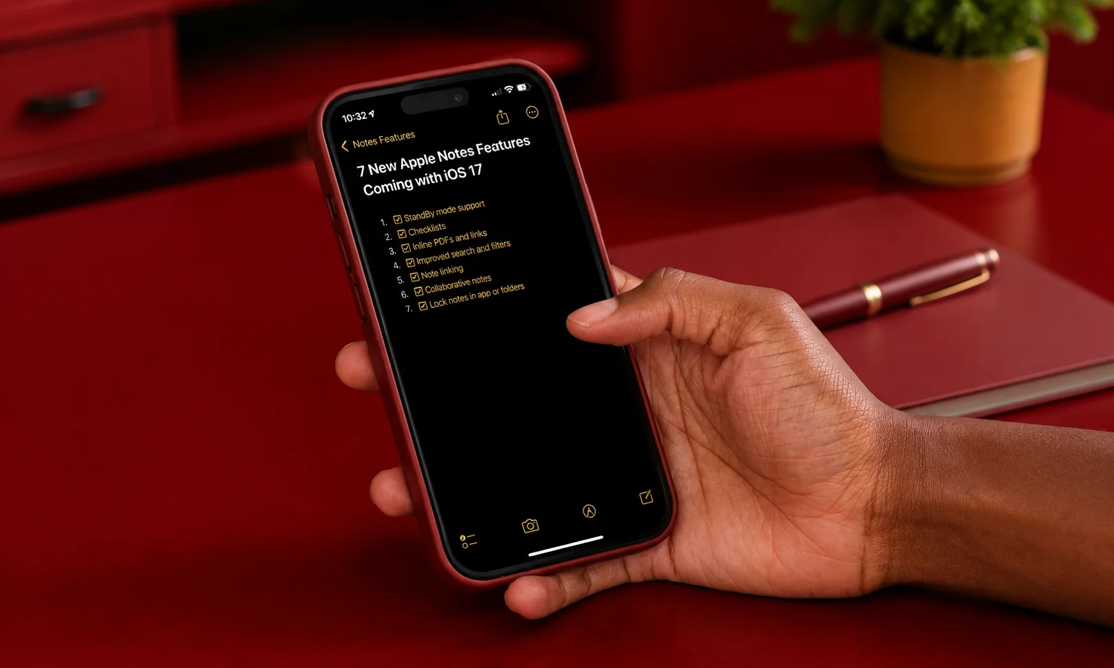 Person holding a smartphone displaying Apple Notes against a dark red background