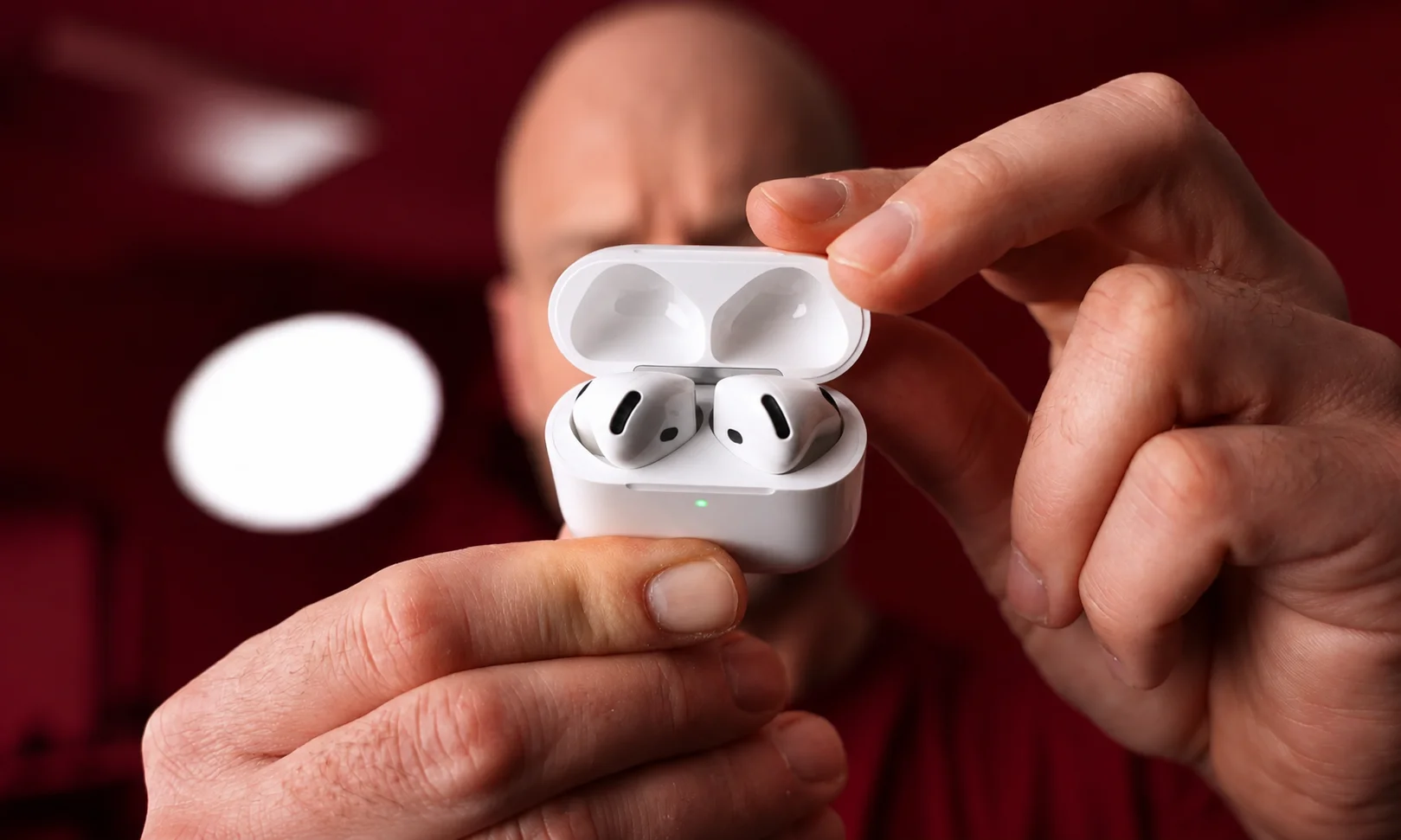 Apple AirPods wireless earbuds with charging case featuring active noise cancellation and compact design
