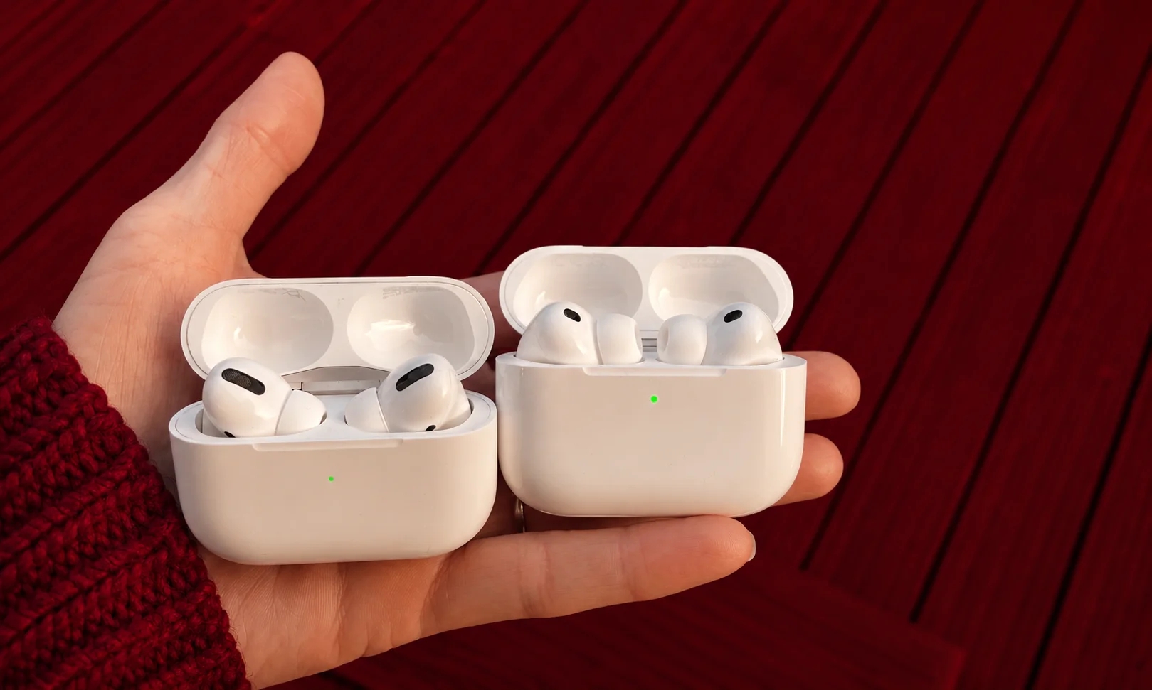 Apple AirPods Pro 3 white charging cases and wireless earbuds held in hand