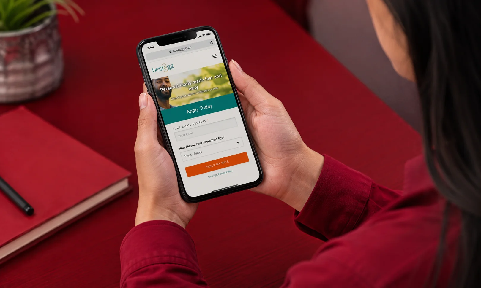 Close-up of a user checking personal loan options and account details on the Best Egg mobile website