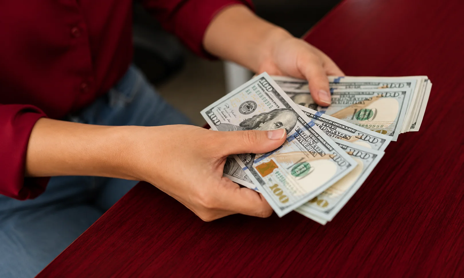 | Best Egg: Personal Loans & Financial Services 2026 Person counting U.S. hundred-dollar bills while managing personal loan funds and monthly payments