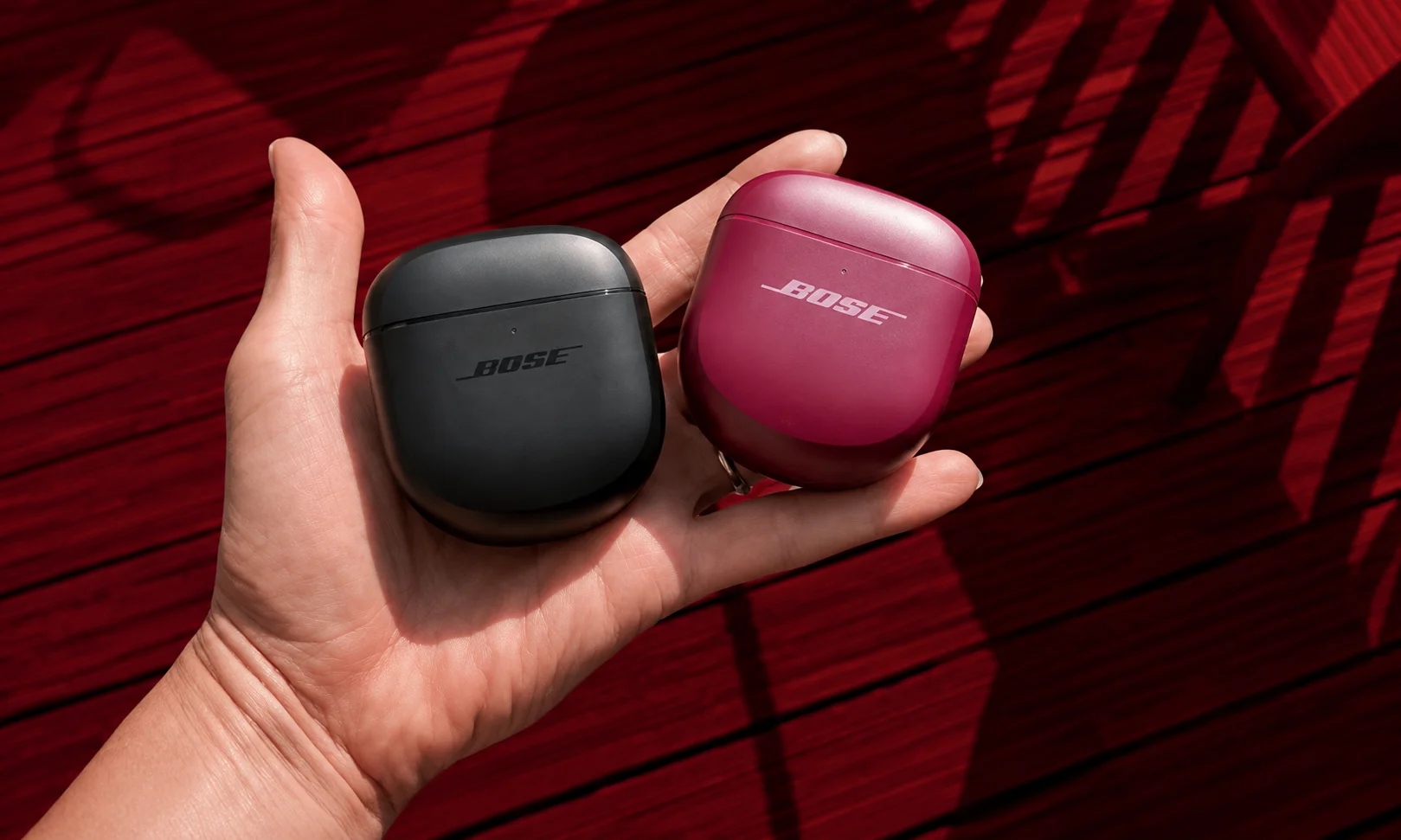 Bose QuietComfort Ultra Earbuds 2nd Gen charging cases in black and plum color options
